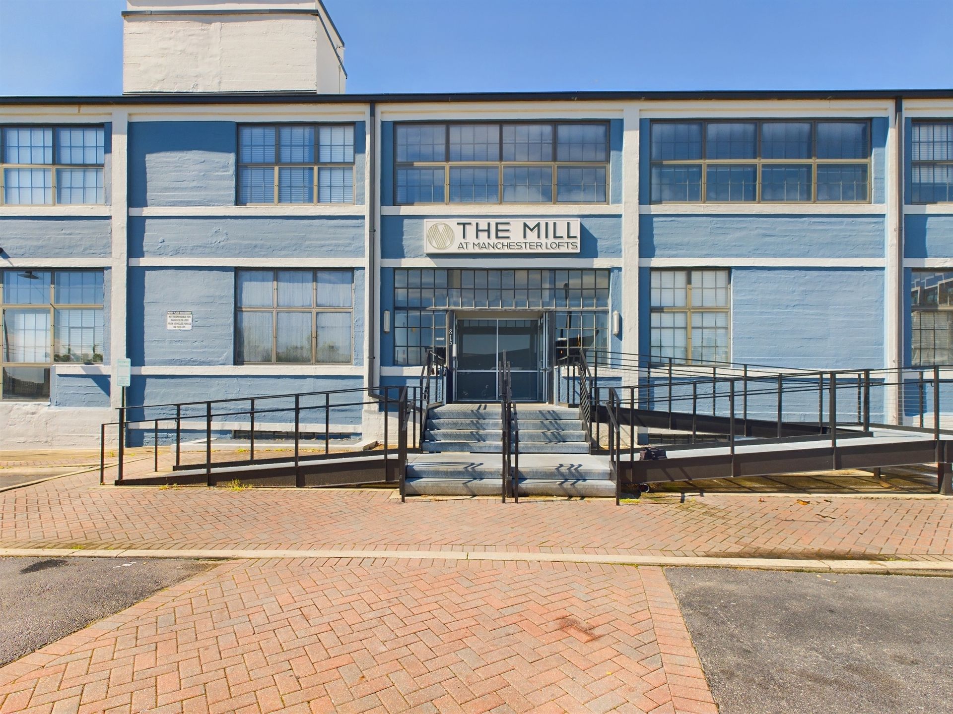 A blue building with a sign that says the mill