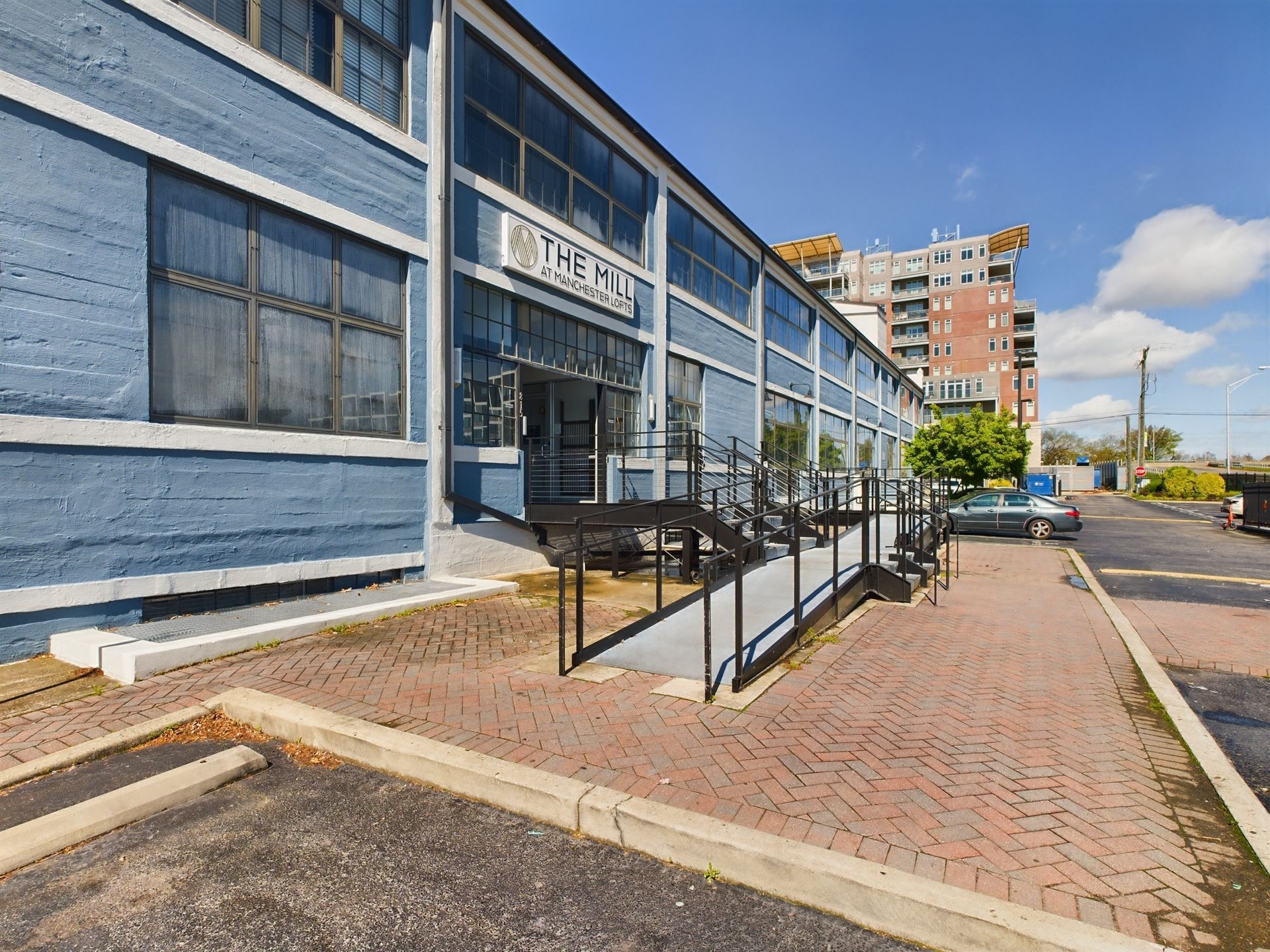 A blue building with a ramp and stairs leading to it