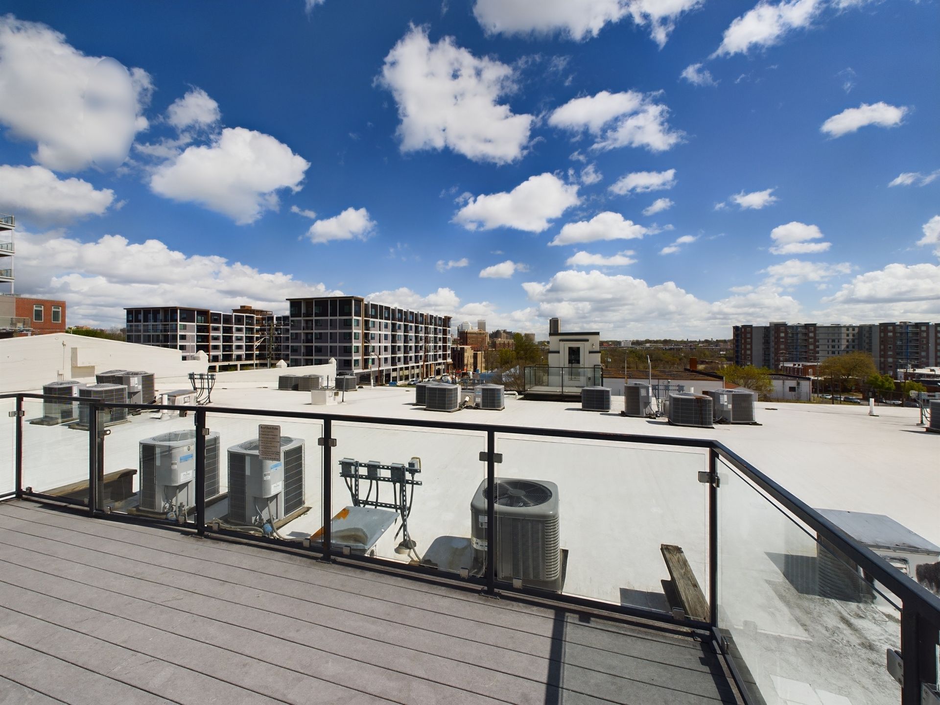 A balcony with a view of the roof of a building
