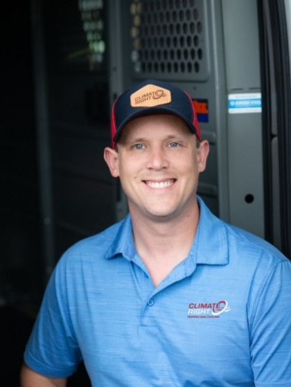 A man wearing a blue shirt with the word climate on it