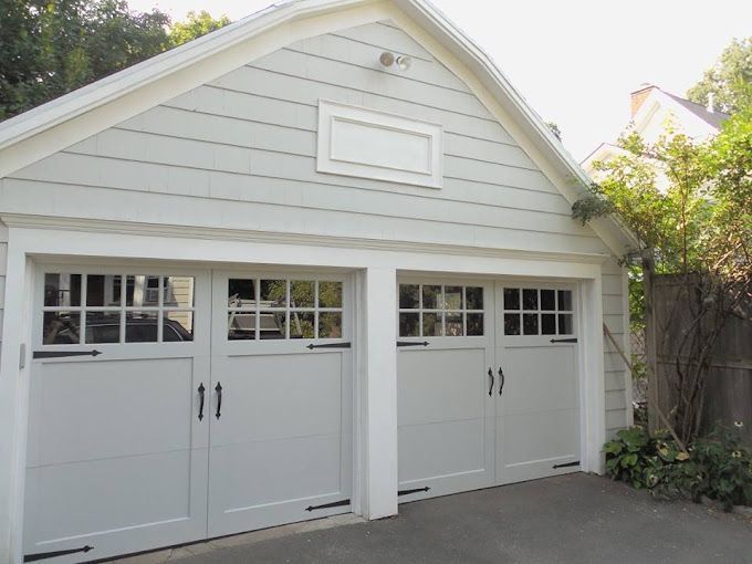 A concrete driveway is being built in front of a house
