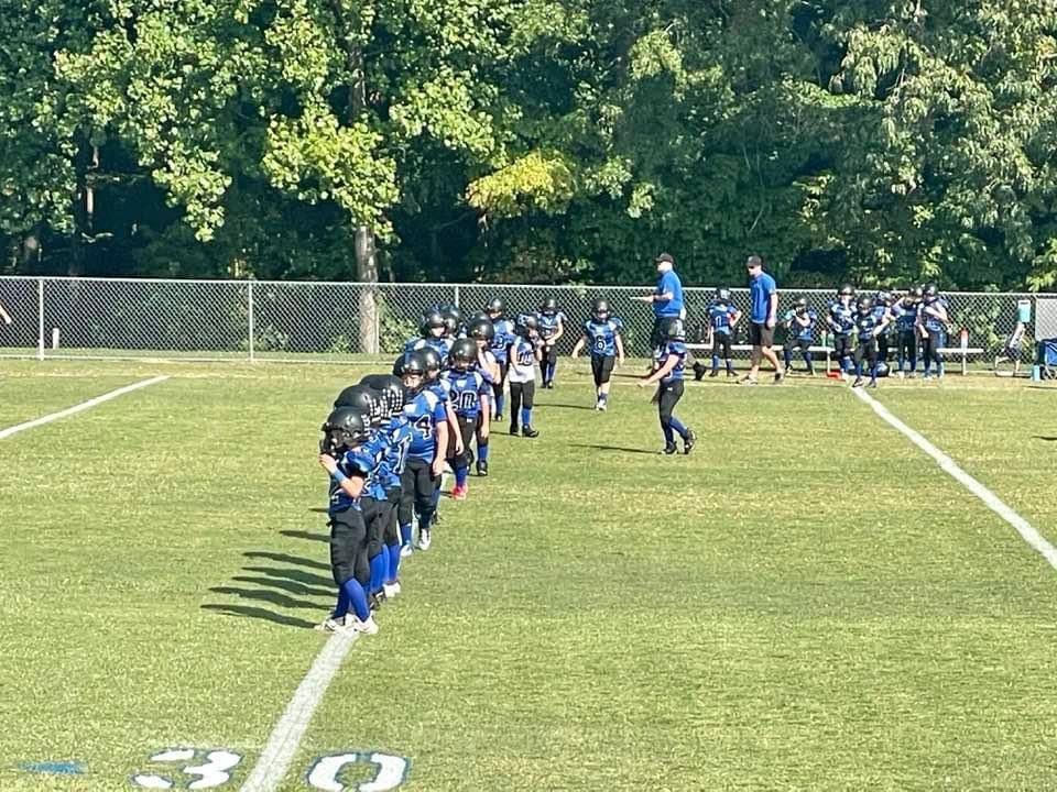 A group of football players are standing on a field.