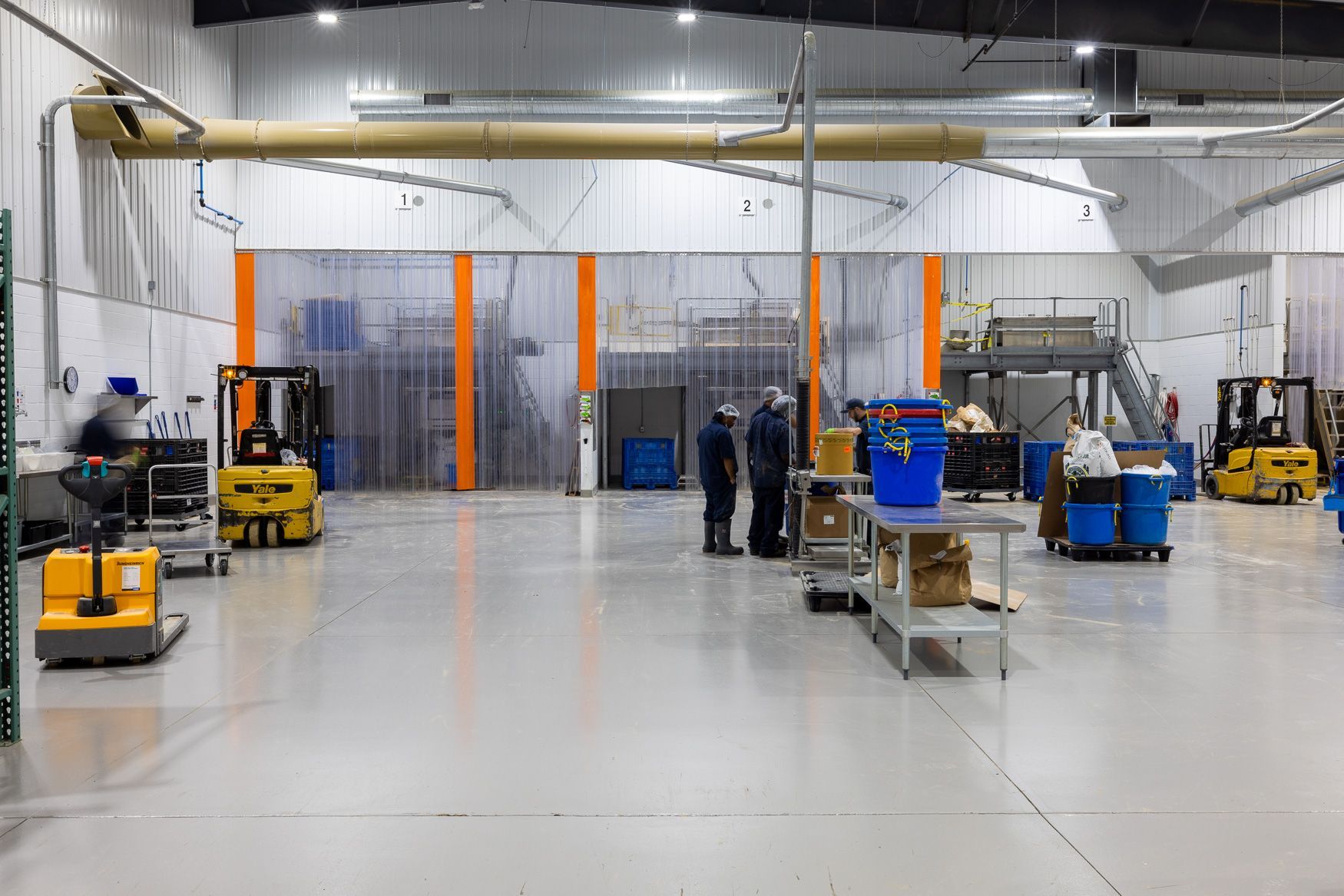 Xtra Factors East Earl, PA warehouse with a lot of forklifts and people working in it.