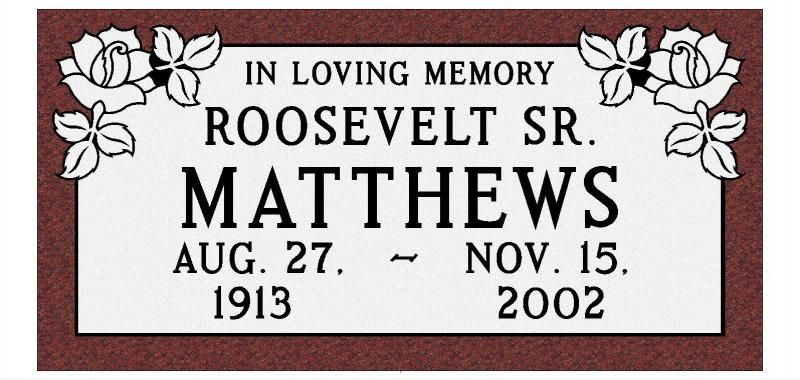 Memorial plaque with white roses reading “In Loving Memory, Roosevelt Sr. Matthews, Aug. 27, 1913 – Nov. 15, 2002”