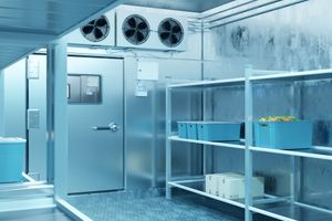 Sterile cold room with metal shelves, ventilation fans, and open industrial door