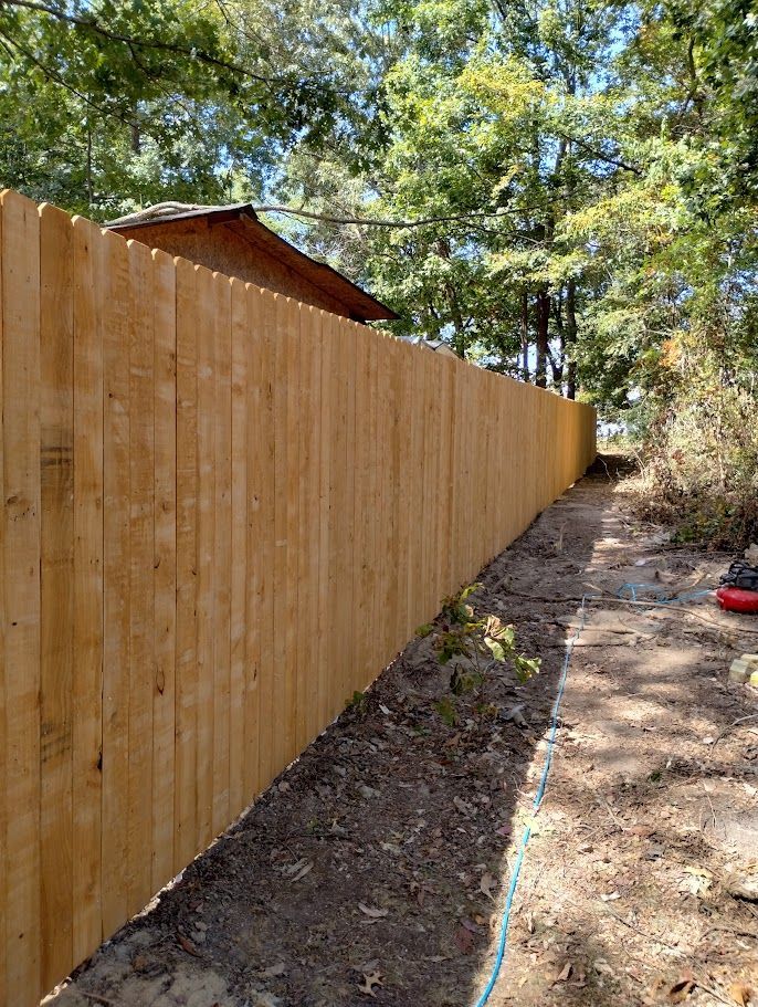 Concrete ramp leading to a small porch with steps and white railings.