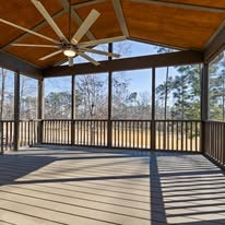Front porch ramp leading to a single-story house with a blue roof and covered porch.