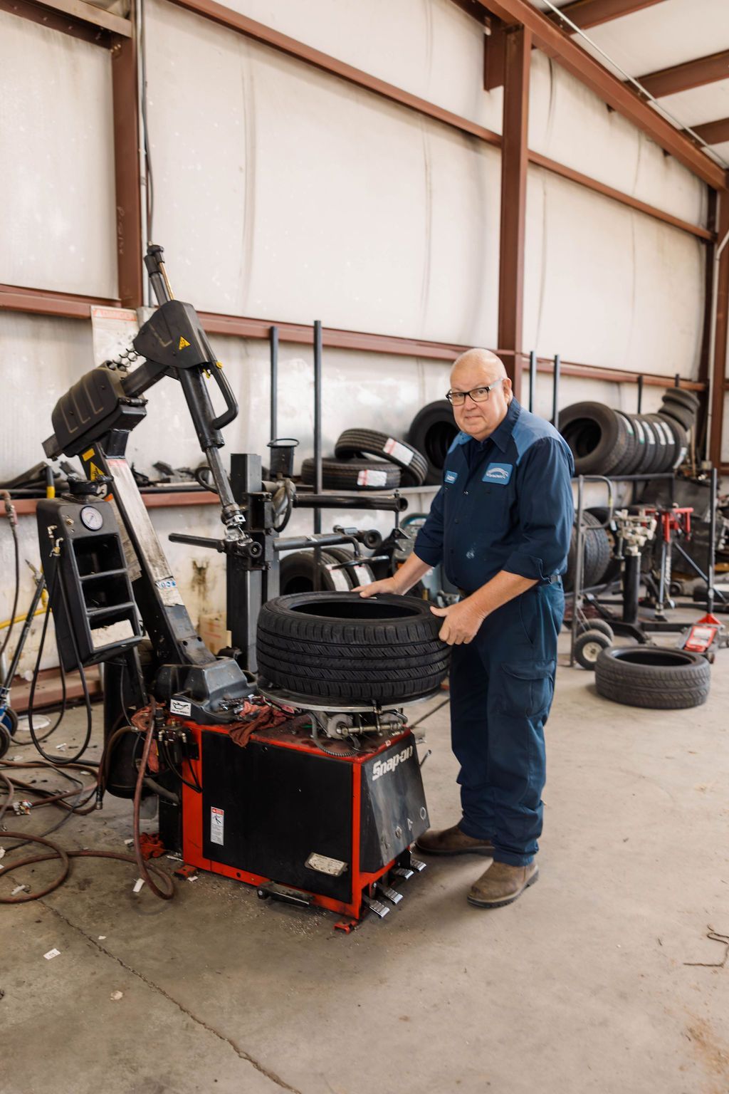 Mechanic working on a tire with a machine | Stephen's Automotive