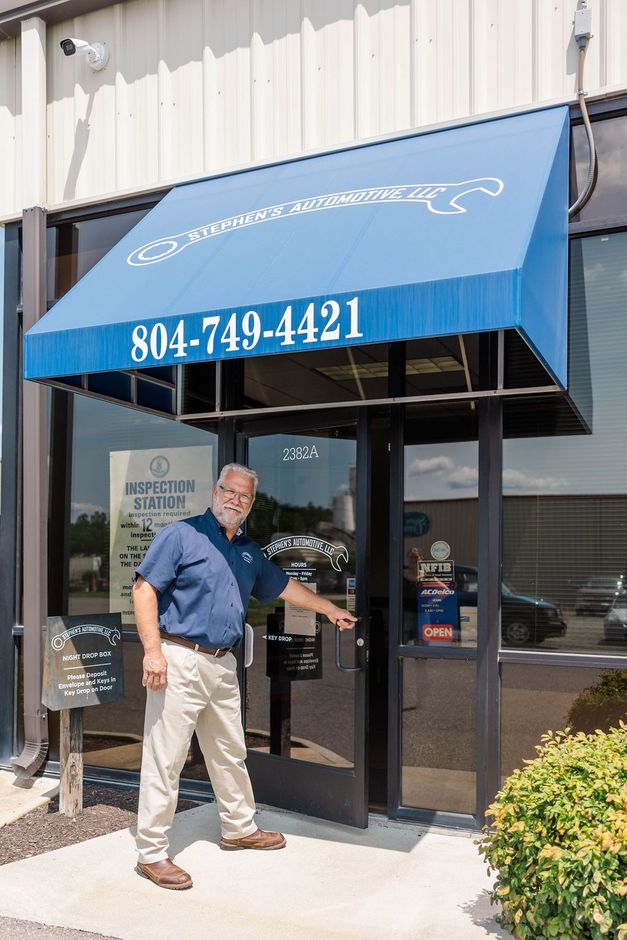 Owner pointing at door of the auto repair shop | Stephen's Automotive