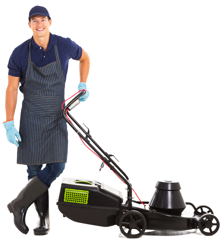 Man wearing apron, gloves, and boots standing next to a black lawnmower, smiling.