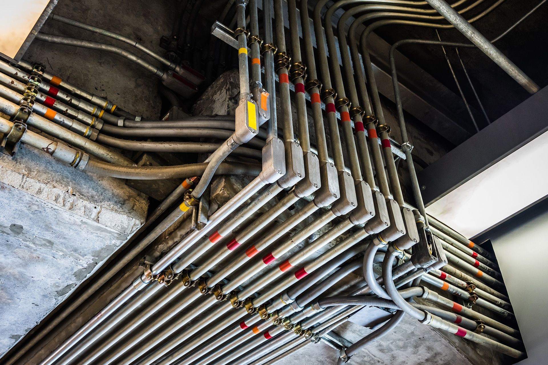 Home inspector checking EMT-bundled electrical conduit and cables