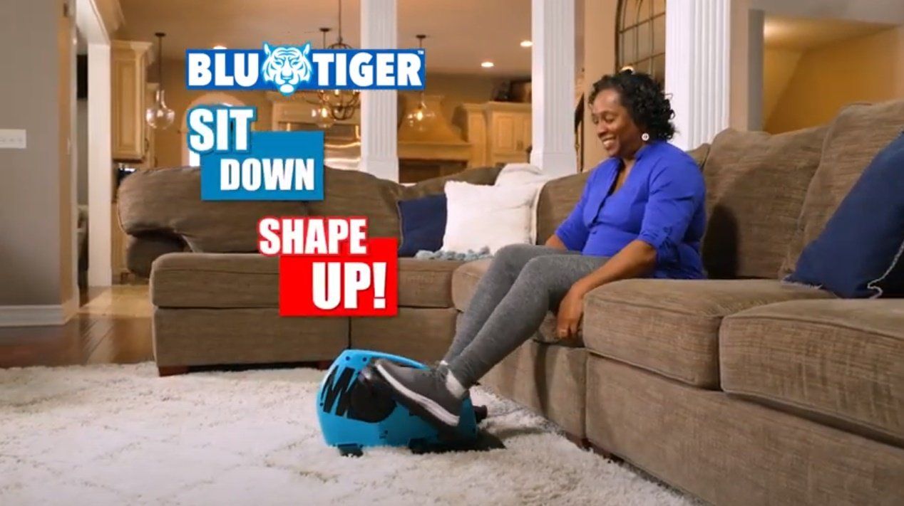 A woman is sitting on a couch with her legs crossed.