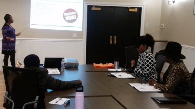A woman is giving a presentation to a group of people