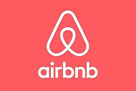 The airbnb logo is on a red background.