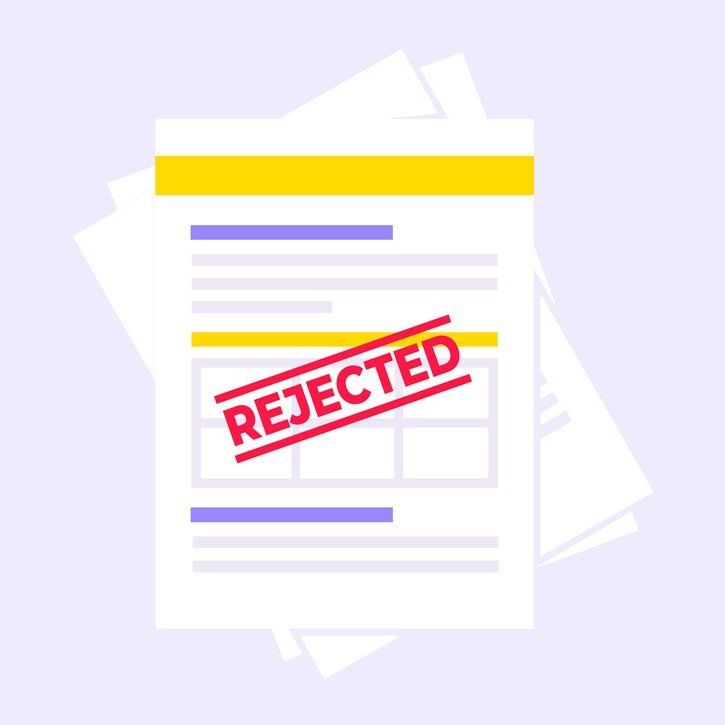A stack of papers with the word rejected stamped on it.