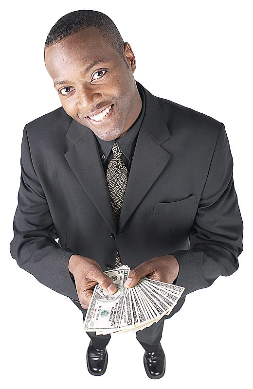 A man in a suit and tie is holding a fan of money.