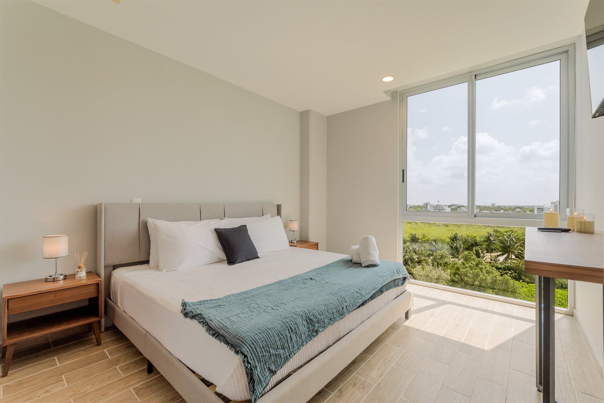 Un dormitorio con una cama king size y una ventana grande.