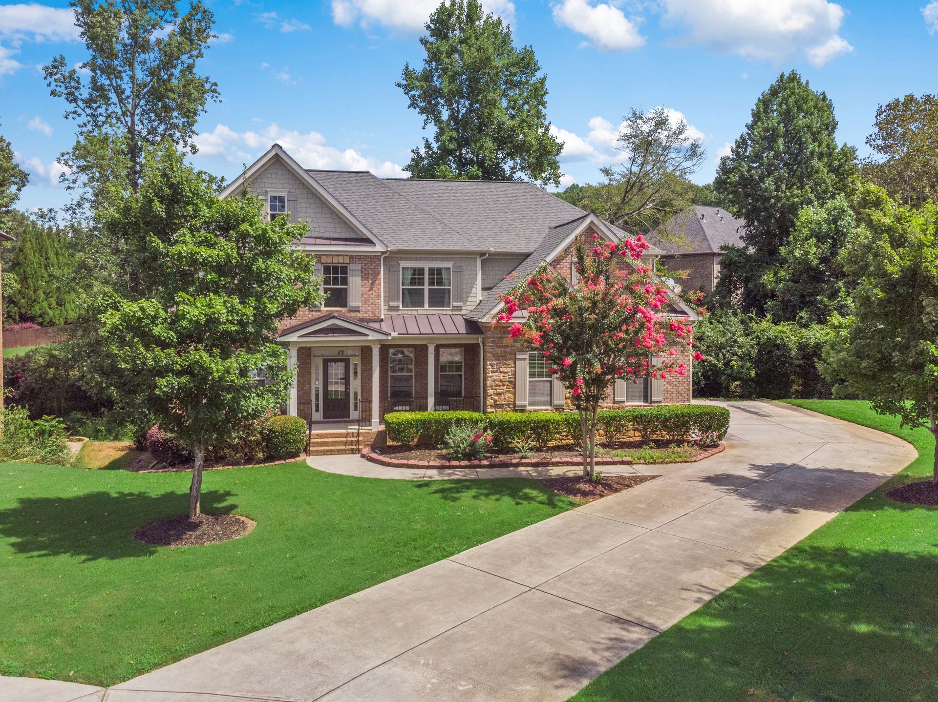 Image of the front exterior of a home with nice spring flowers.
