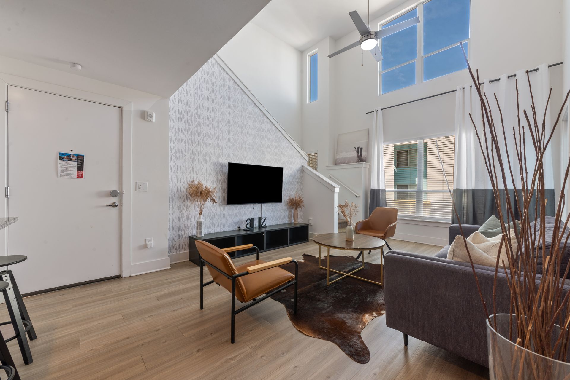 Interior of an apartment with lots of natural light and nicely staged.