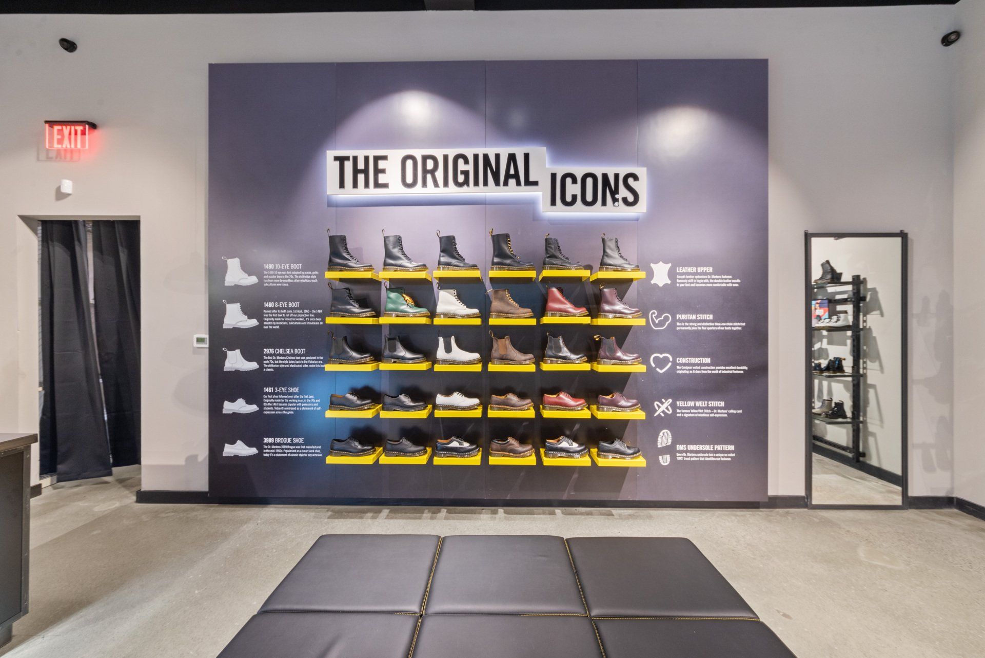 Dr. Martens store display: boots on shelves against a wall with 