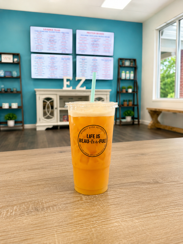 Loaded teas and energy drinks served on a bright nutrition counter with fruit garnishes.
