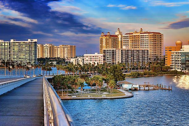 A bridge over a body of water with a city in the background.