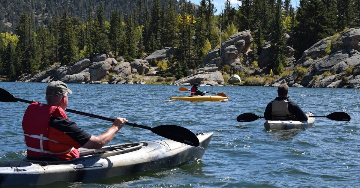 group of people on a lake in kayaks