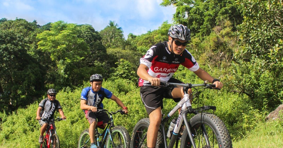 A group of people are riding bikes on a trail in the woods.