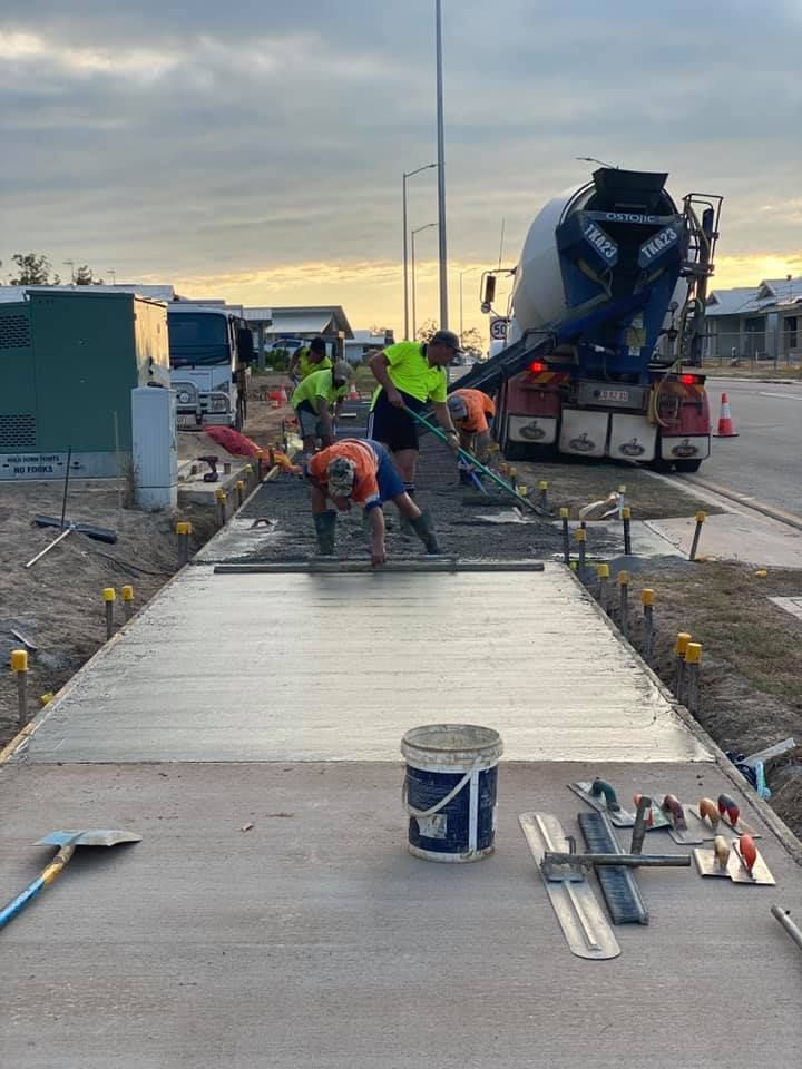 Workers Are Working Applying Concrete On The Road — JLM Contracting Services Pty Ltd in Virginia, NT