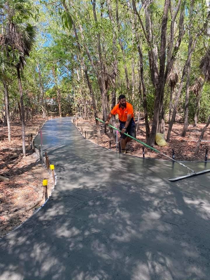 A Man Spreading The Concrete On The Ground — JLM Contracting Services Pty Ltd in Jabiru, NT