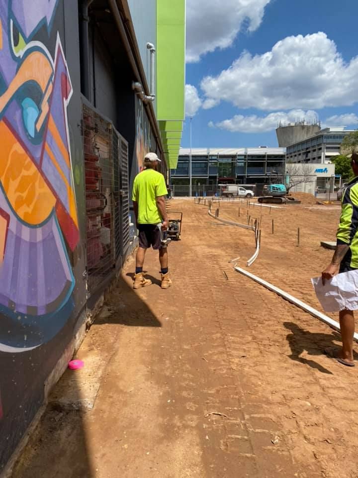 Concreters Beside The Building — JLM Contracting Services Pty Ltd in Humpty Doo, NT