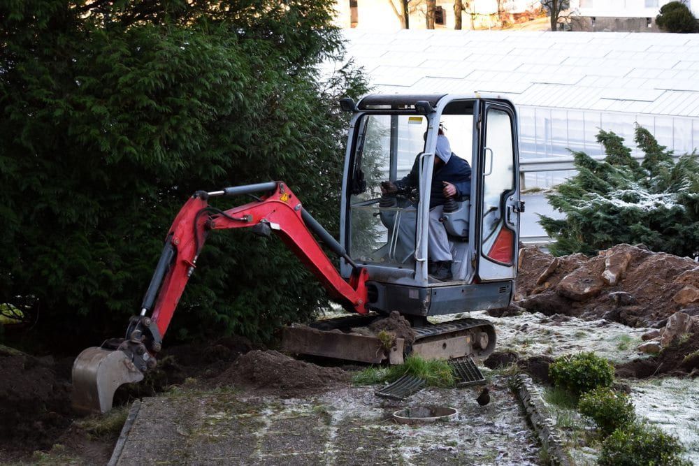 A Worker Uses Mini Excavator — JLM Contracting Services Pty Ltd in Jabiru, NT