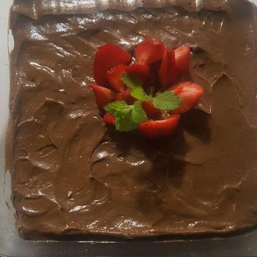 A chocolate cake with strawberries on top of it