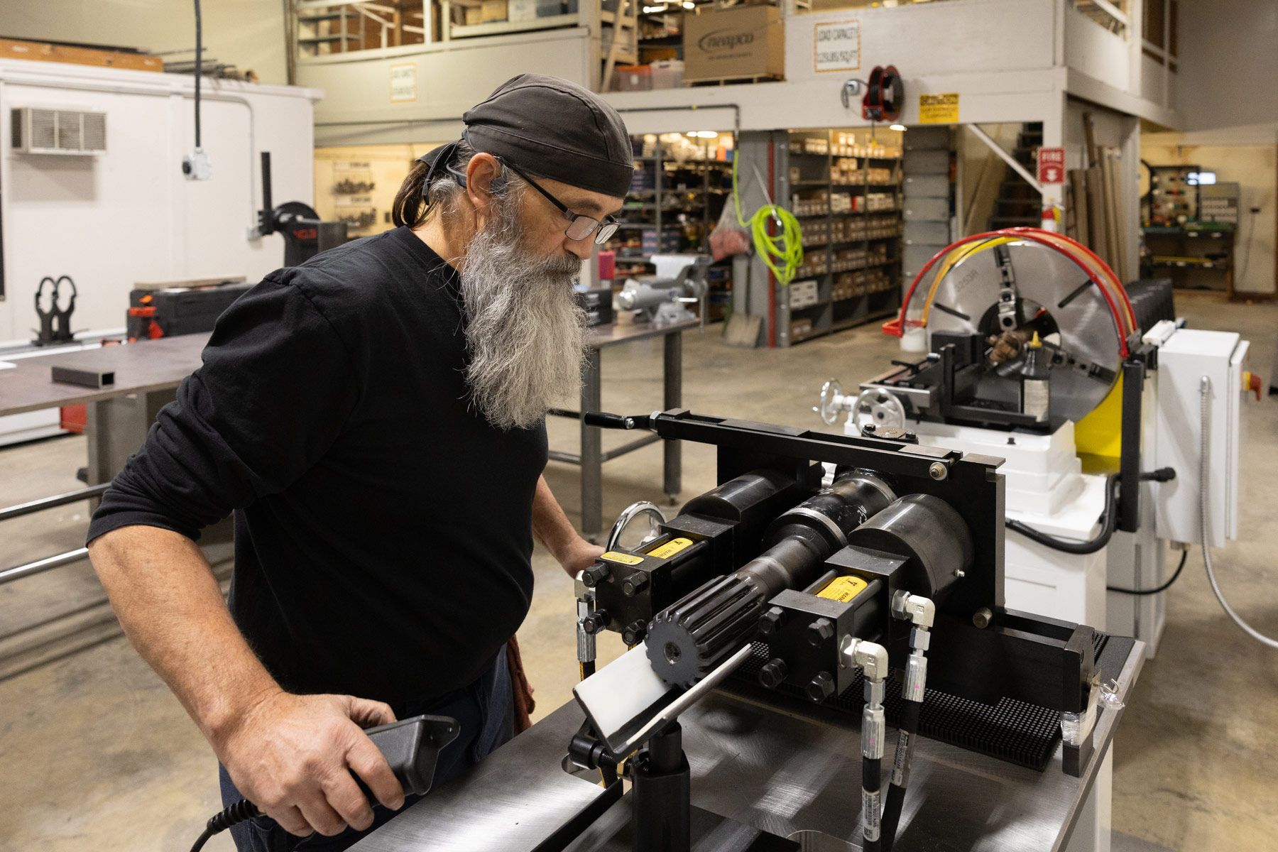 Man operating driveshaft balancing machine in Bahler Repair shop. 