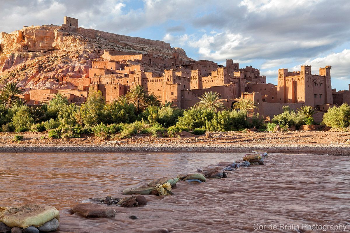Clay buildings and fortress at Ait Benhaddou, Morocco, bathed in warm sunlight.