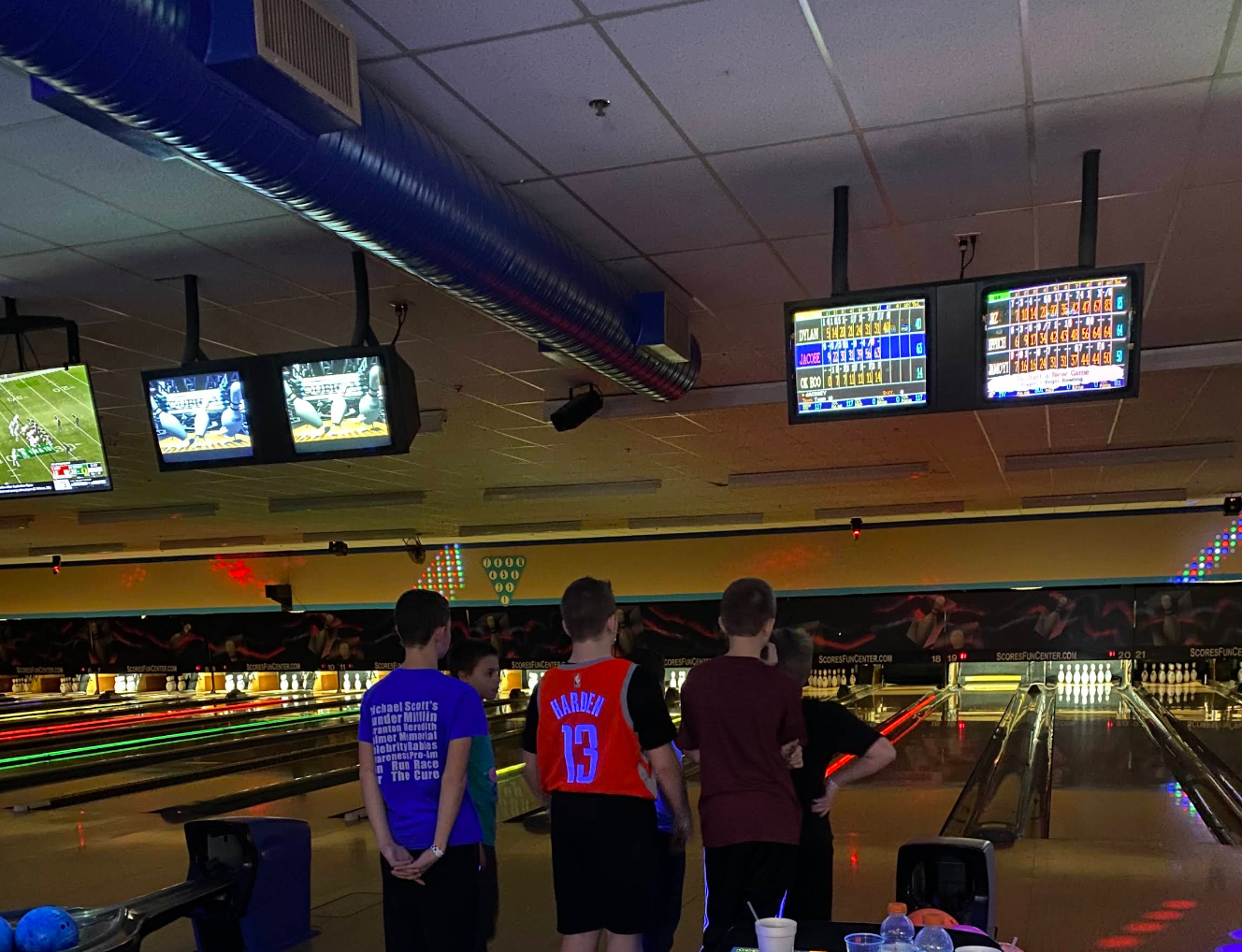 Children's birthday party at a bowling alley &mdash; colorful balloons, kids in rental shoes, birthday cake