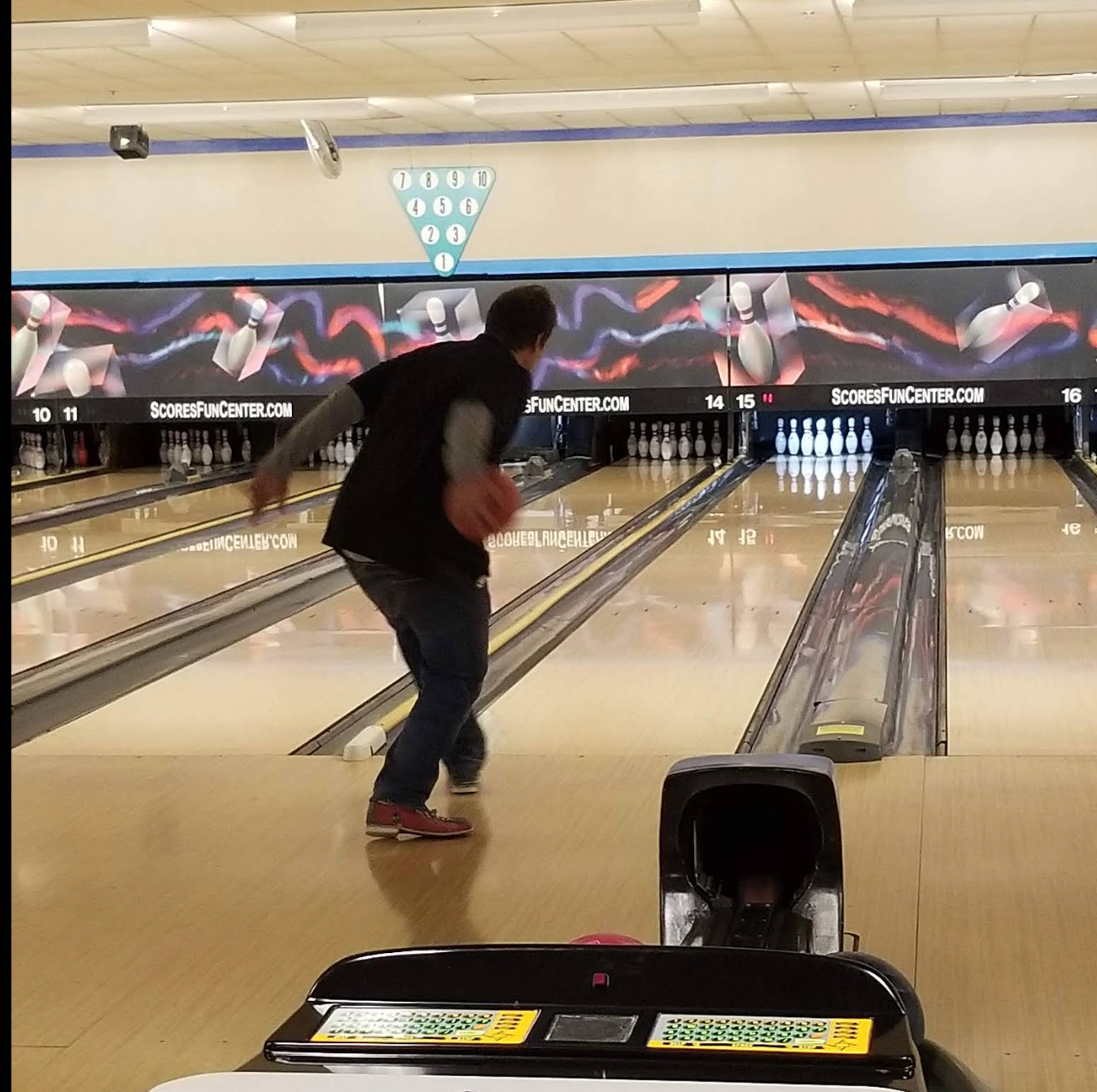 Bowler mid-action on a lane, motion blur on the ball, 1970s-80s clothing style