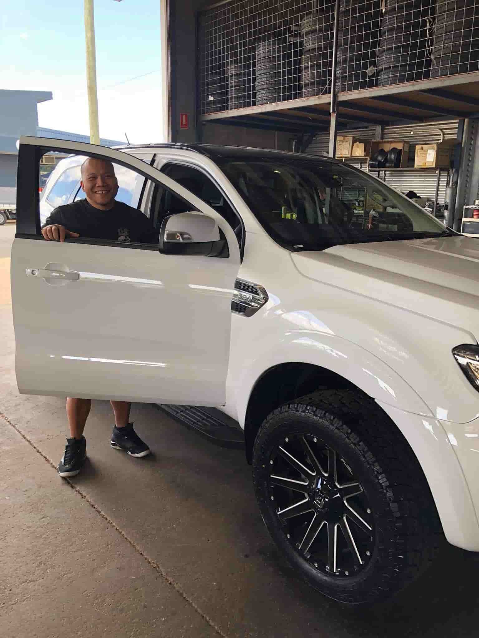 A Man Standing Next to A White Truck — Torque Tyres & Trailer Spares Cairns in Cairns, QLD