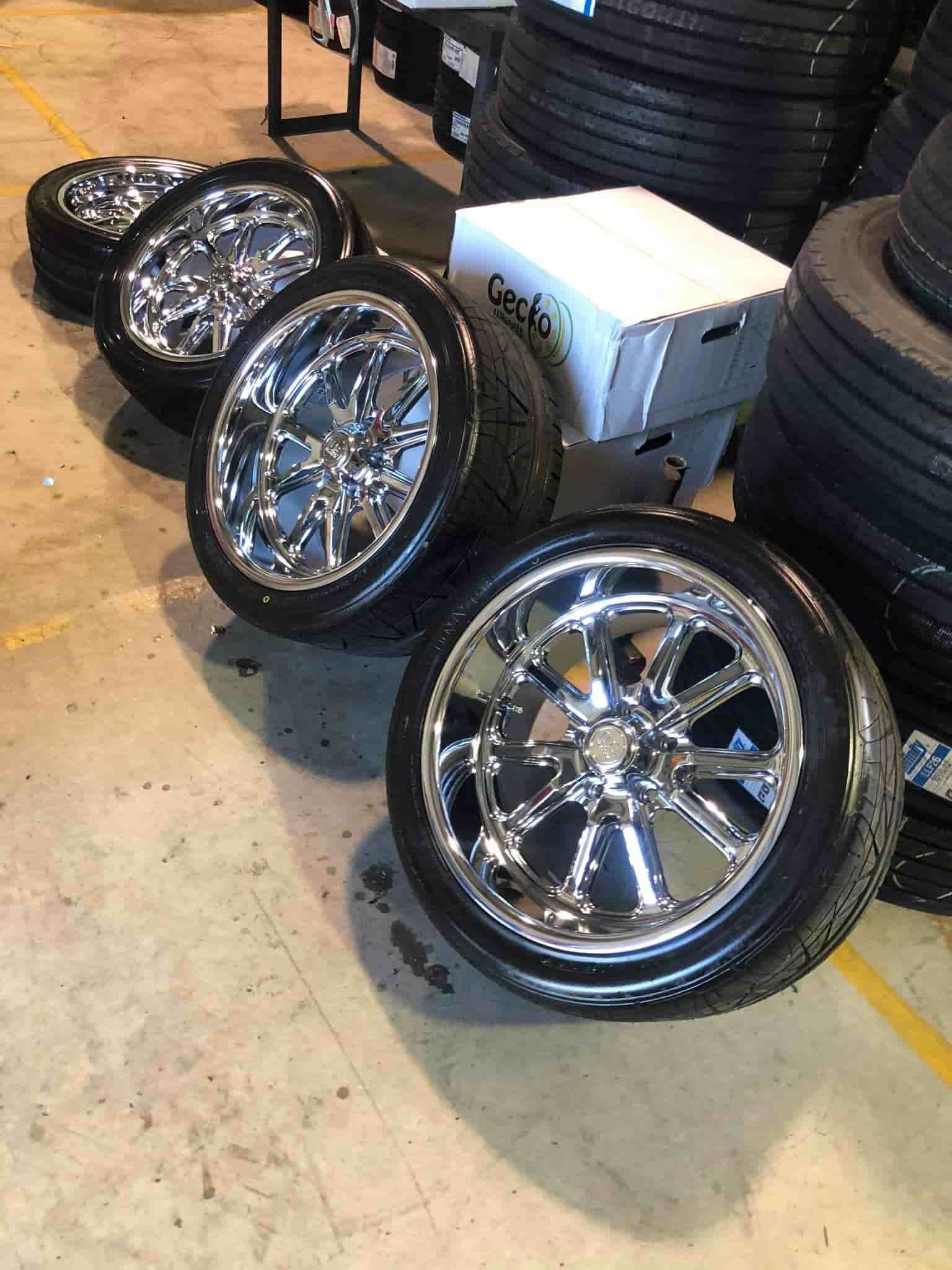 A Row of Chrome Wheels and Tires on A Concrete Floor — Torque Tyres & Trailer Spares Cairns in Cairns, QLD