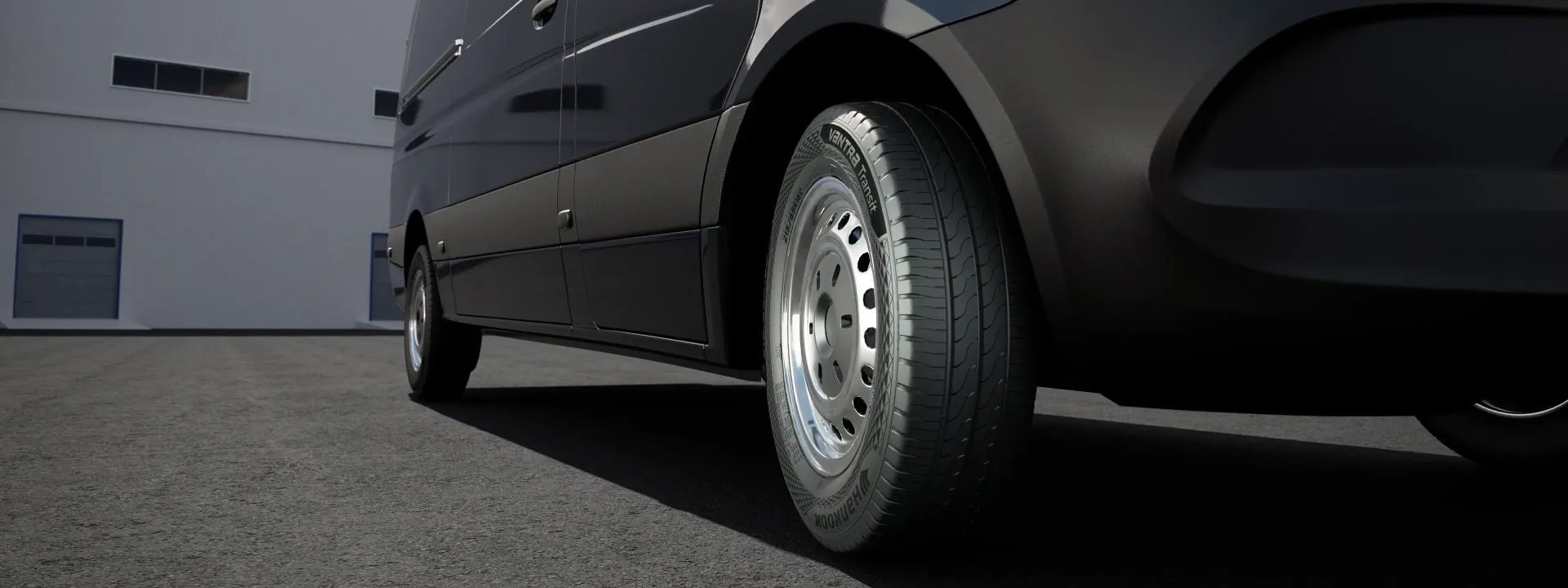 Close-up of a Black Van's Tires on a Gray Asphalt Surface — Torque Tyres & Trailer Spares Cairns in Cairns, QLD