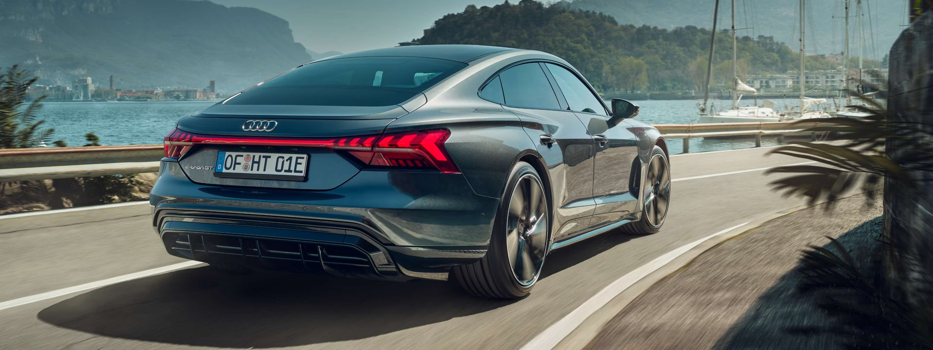 A Dark Gray Audi E-tron Gt Driving Along a Coastal Road — Torque Tyres & Trailer Spares Cairns in Cairns, QLD