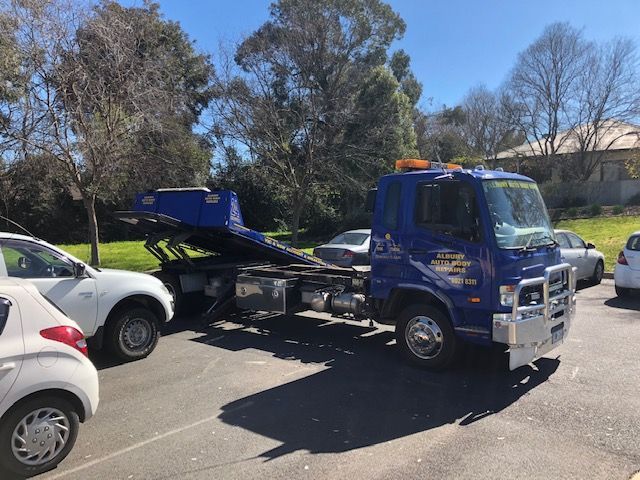 A Blue tilting tow truck — Crossborder Towing in Lavington, NSW