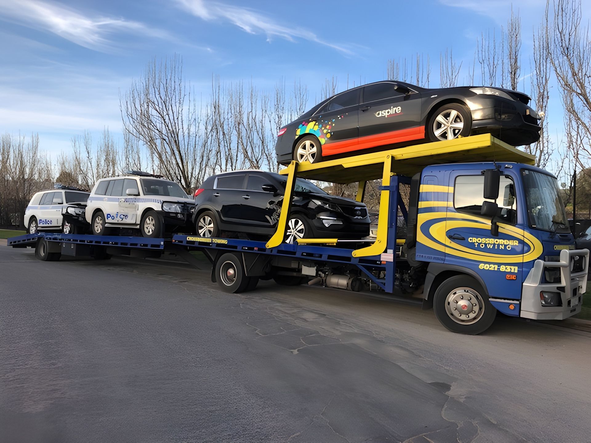 A Tow Truck is Carrying a Stack of Cars on Top of It — Crossborder Towing in Baranduda, VIC