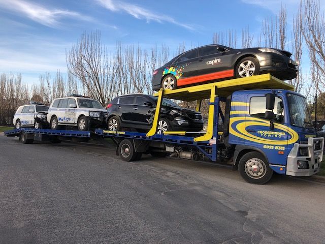 A Tow Truck is Towing a Car on the Highway — Crossborder Towing in Mount Beauty, VIC