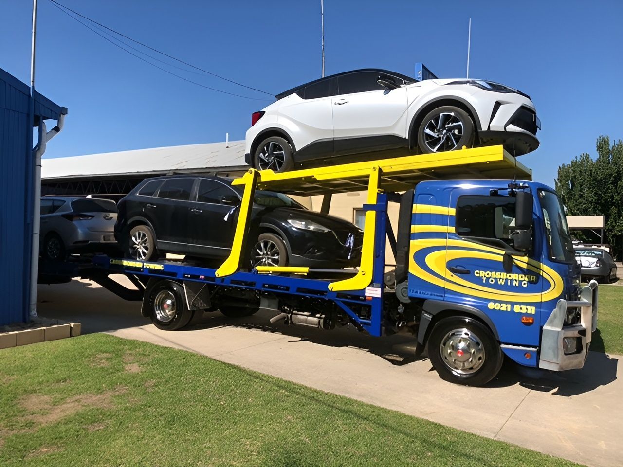 A tow truck with cars loaded onto it — Crossborder Towing in South Albury, NSW