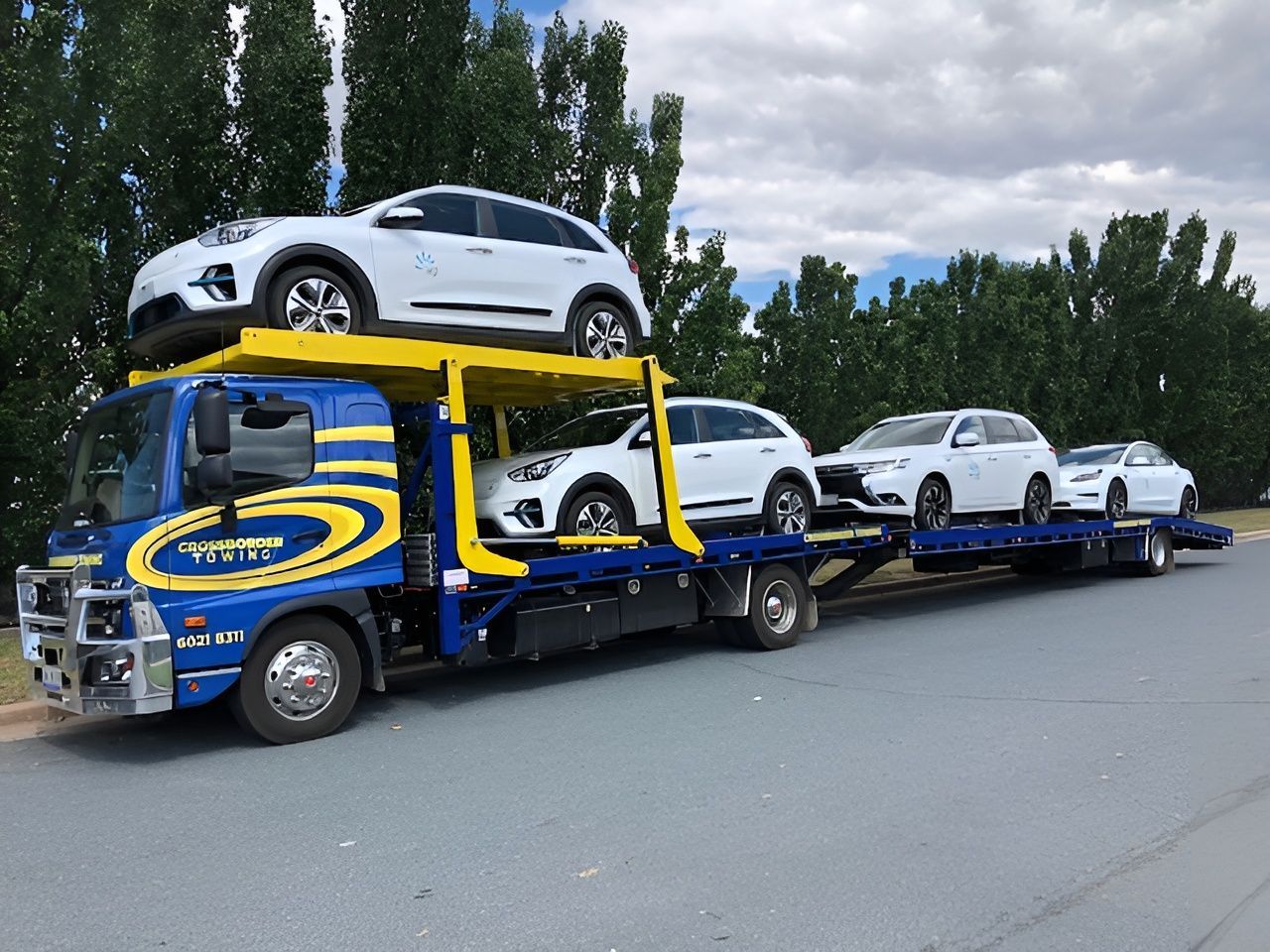 A Tow Truck is Carrying a Car on Top of It — Crossborder Towing in Baranduda, VIC