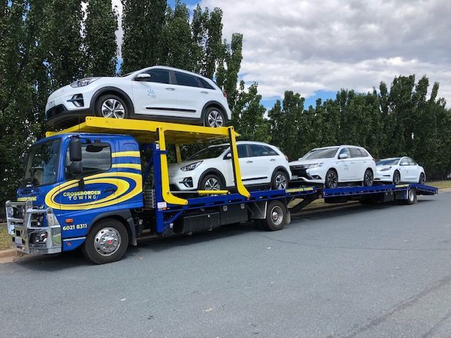 A Tow Truck is Towing a Car on the Highway — Crossborder Towing in Beechworth, NSW