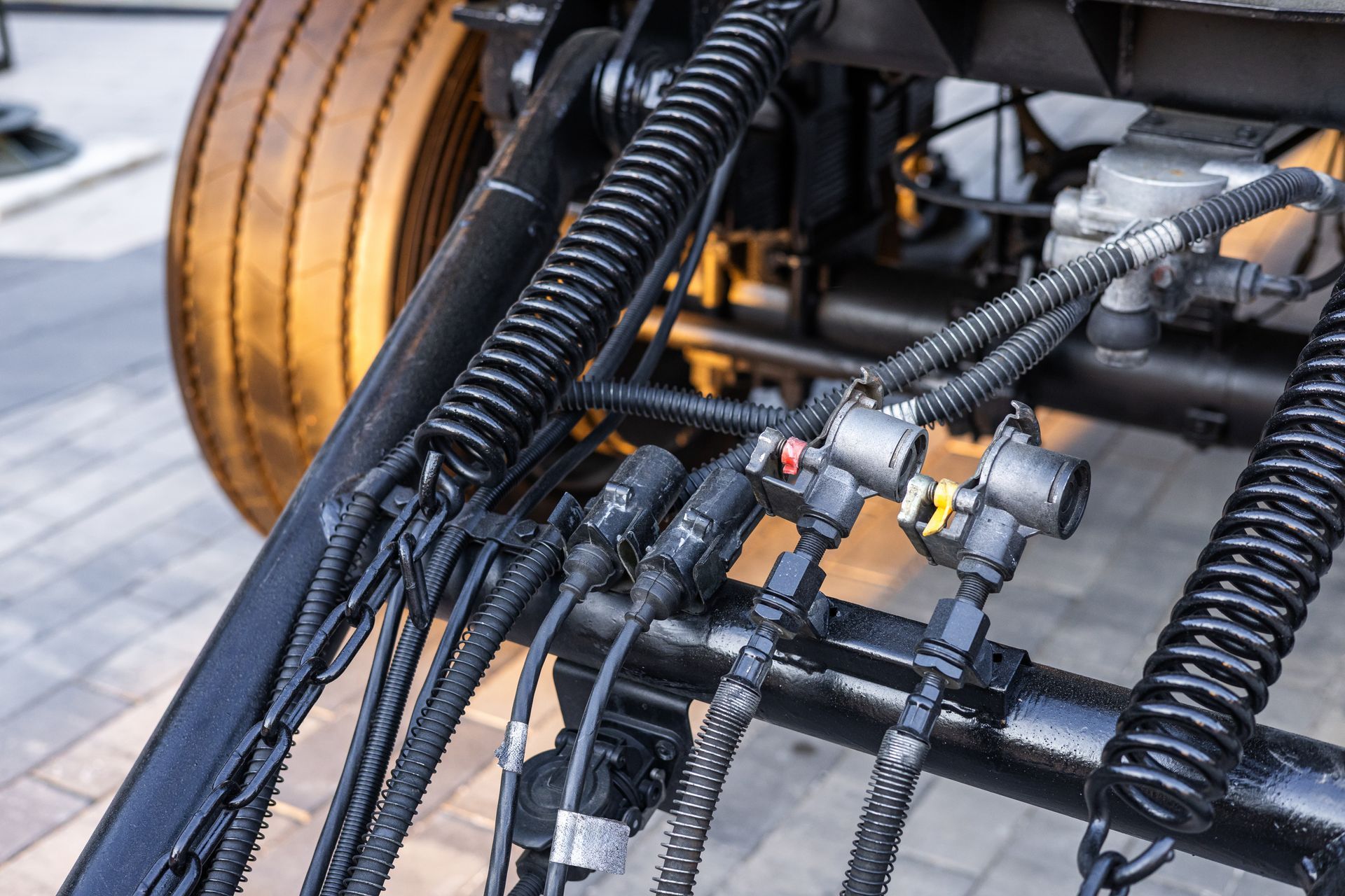 Tight focus hydraulic hose junction detail.