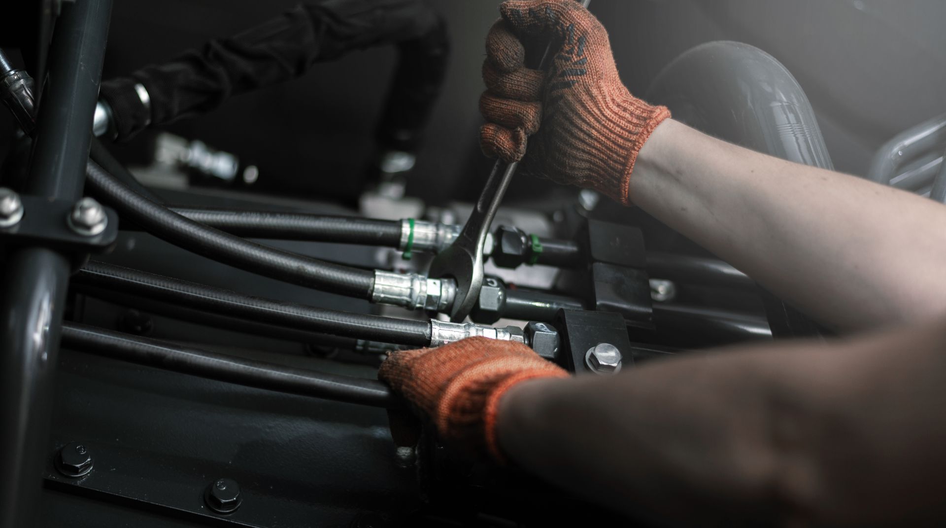 Close-up of hydraulic hoses and fittings on industrial equipment