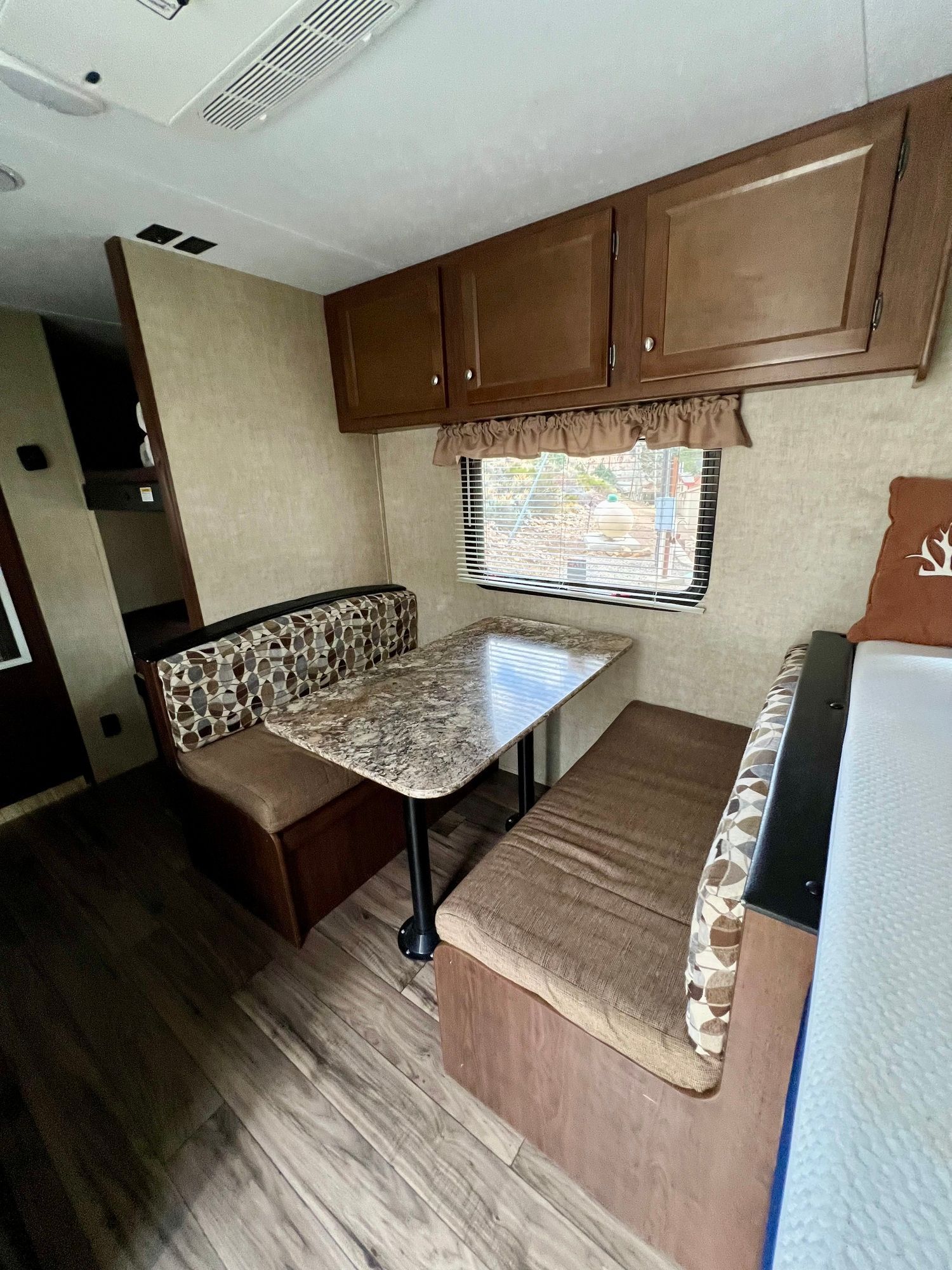 A rv with a table and benches in it.